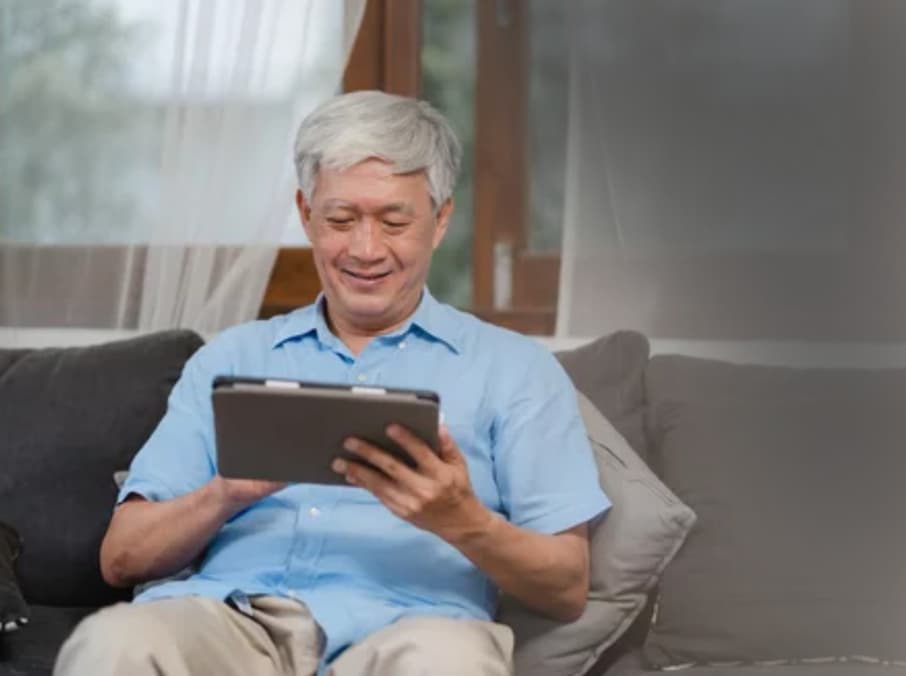 asian senior patient using tablet registration doctor office